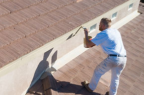 Painter applying an exterior finish